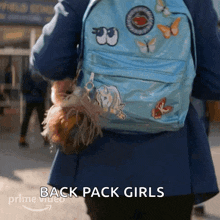 a person is wearing a blue backpack that says back pack girls