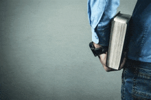 a man is holding a bible in his hands .