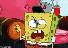 spongebob squarepants is sitting on a couch with a bucket on his head and making a fist .