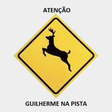 a yellow sign with a deer and the words atenção