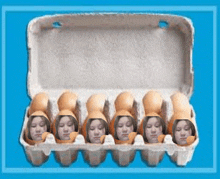 a carton of eggs with a woman 's face cut out of each egg