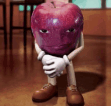 a cartoon apple with arms and legs is sitting on the floor with his arms crossed .