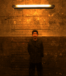 a man standing in front of a wall that says 2 meters