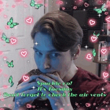 a man is eating a sandwich in a room with hearts and butterflies .