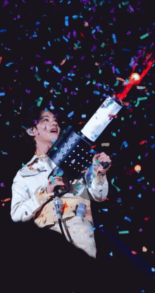 a man is holding a confetti cannon in his hands