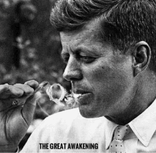 a black and white photo of a man smoking a pipe with the words the great awakening above him