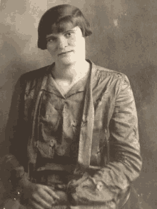 a black and white photo of a woman wearing a jacket