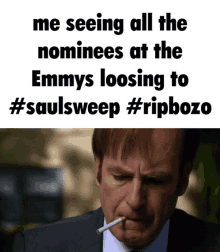 a man in a suit smoking a cigarette next to a meme about emmys loosening