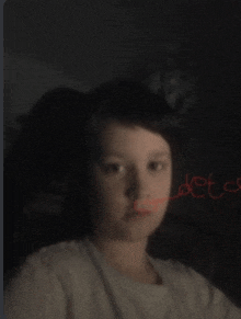 a child 's face is visible in a blurry photo with the word deta written on the bottom right