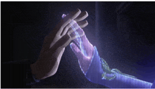 a person holding another person 's hand that is glowing