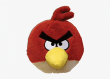 a stuffed angry bird with a yellow beak and black eyes