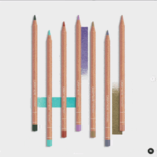 a row of caran d' ache colored pencils on a white surface