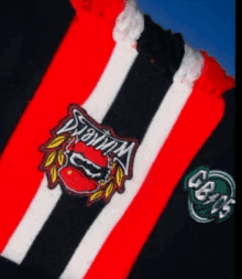 a red white and black striped scarf with a logo on it that says dawson fc