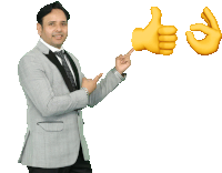 a man in a suit is pointing at two thumbs up emojis