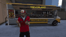 a man is standing in front of a food truck that says trevorland