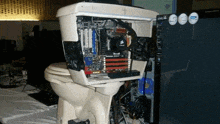 a toilet with a computer inside of it and a corsair motherboard