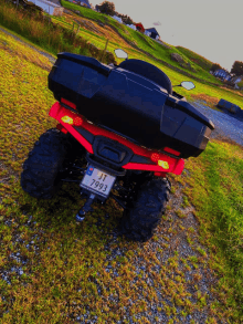 a red atv with a license plate that says jt 7993