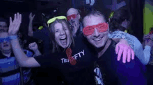 a man and a woman are posing for a picture at a party .