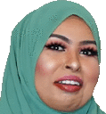 a close up of a woman wearing a green hijab and smiling .