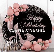 a happy birthday sign for santia and dashia is surrounded by pink balloons