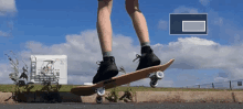 a person is riding a skateboard on a sidewalk with a laptop in the background