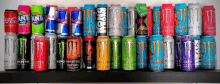 several cans of monster energy drinks are lined up