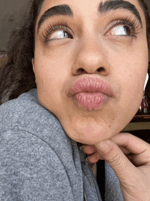 a close up of a woman making a face