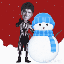 a man in a skeleton costume standing next to a snowman