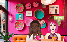 two women sit at a table with cups of coffee in front of a wall that says latte and coffee