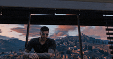 a man wearing sunglasses looks out a window at a city