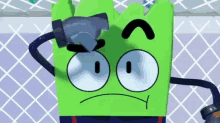 a green cartoon character with a hammer on his head is standing next to a fence .