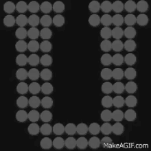 the letter u is surrounded by white dots on a black background .