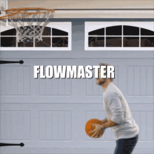 a man is playing basketball in front of a garage door and the word flowmaster is above him