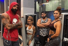 a group of people are standing in a gym with their arms crossed .