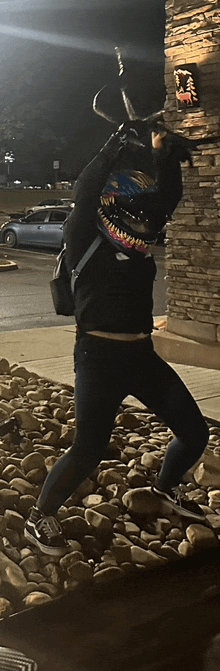 a person standing in front of a brick wall with a sign that says ' steak ' on it