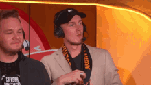 a man wearing headphones has a scarf around his neck that says suensha