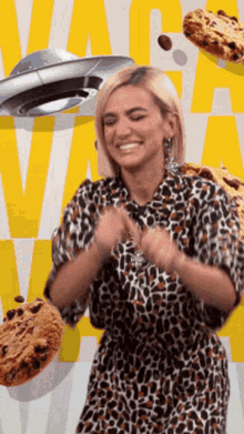 a woman in a leopard print dress is smiling in front of a collage of cookies and a flying saucer