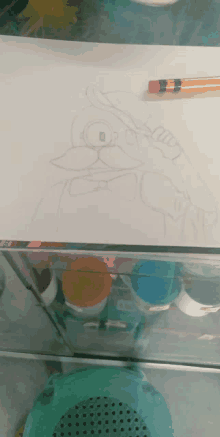 a drawing of a duck with a hat and bow tie is being drawn on a piece of paper