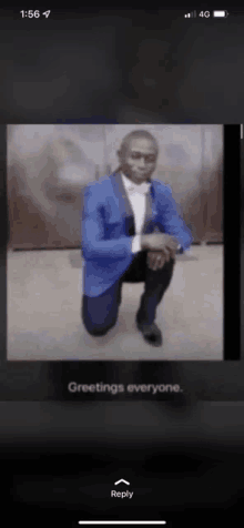 a man in a blue suit and bow tie is kneeling down with greetings everyone written below him