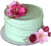 a green cake with pink and red flowers on top