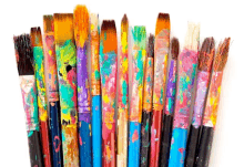 a bunch of paint brushes covered in colorful paint on a white background