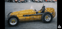 a car made out of corn on the cob is parked in a parking lot