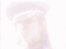 a close up of a person wearing a hat and a microphone .