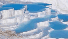 a large body of water surrounded by snow and rocks