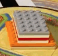 a close up of a stack of lego blocks on a table .