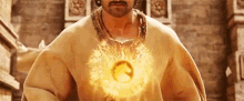 a man with a beard and mustache is holding a golden object in his chest .