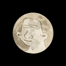 a full moon with a drawing of a face on it