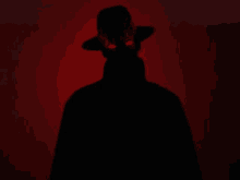 a silhouette of a man in a hat with red eyes .