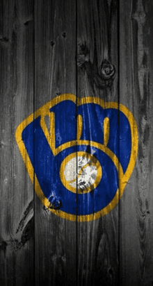 a blue and yellow logo is painted on a wooden surface