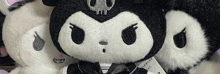 a close up of a stuffed animal with a skull on it .